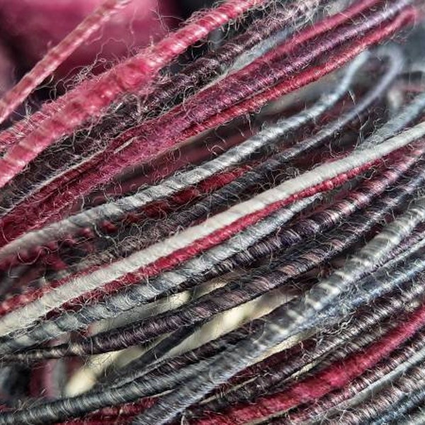 Wool fiber wire in black, gray, white and reddish purple.  Wool, silk, and bamboo blend.