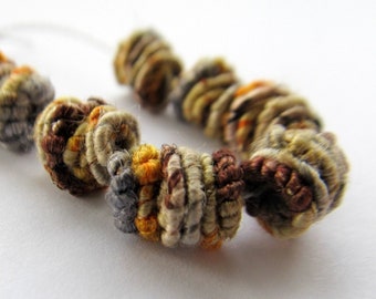 Handmade fiber beads.  Yarn coated wire coiled beads.  8-9mm X 7-8mm beads.  Linen and nylon coated beads.