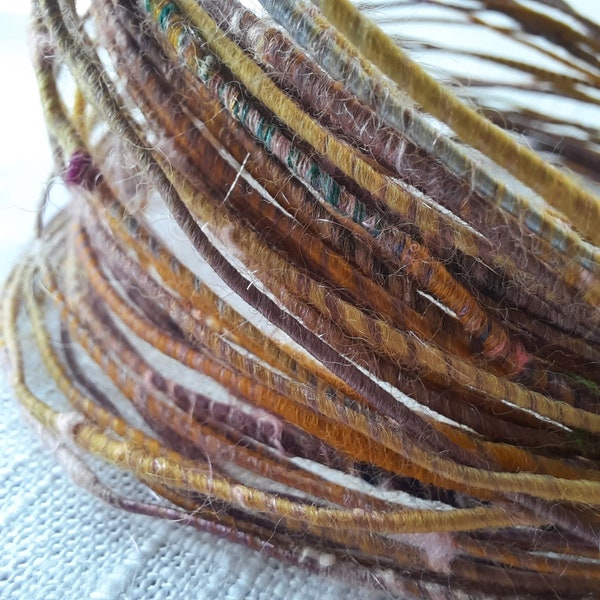 Wool fiber wire.  Pale purlpe/mauve, golden orange wool with silk and recycled silk saris