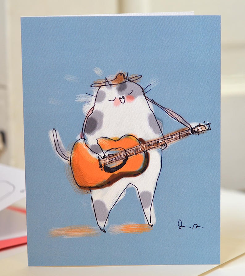 May include: A cartoon illustration of a white cat with gray spots wearing a cowboy hat and playing an orange acoustic guitar on a light blue background.