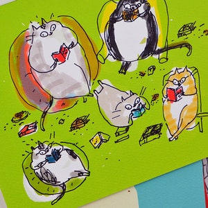 May include: A green card with a hand-drawn illustration of five cats reading books. The cats are sitting in chairs and on the floor. There are small brown and yellow objects scattered around the cats. The card is signed "A.C."