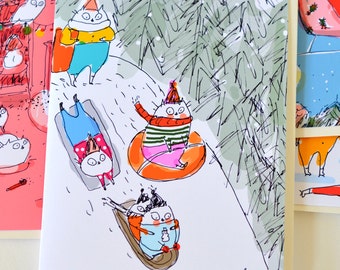 May include: A white card with a hand-drawn illustration of four cats in a snowy forest. The cats are wearing winter clothing and are sledding, tubing, and sitting on a log. The card is signed "f.a."