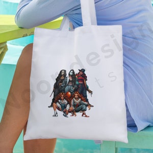 May include: White tote bag with a graphic print of five women dressed as horror movie characters. The characters are wearing masks and costumes. The women are holding weapons and posing in a menacing way.