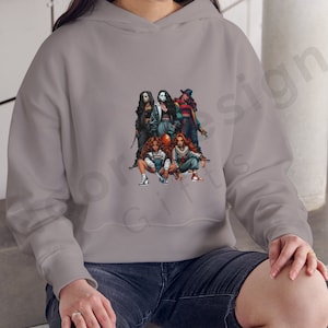 May include: A gray hoodie with a graphic print of five women dressed as horror movie characters. The women are holding weapons and wearing masks. The graphic is centered on the hoodie.