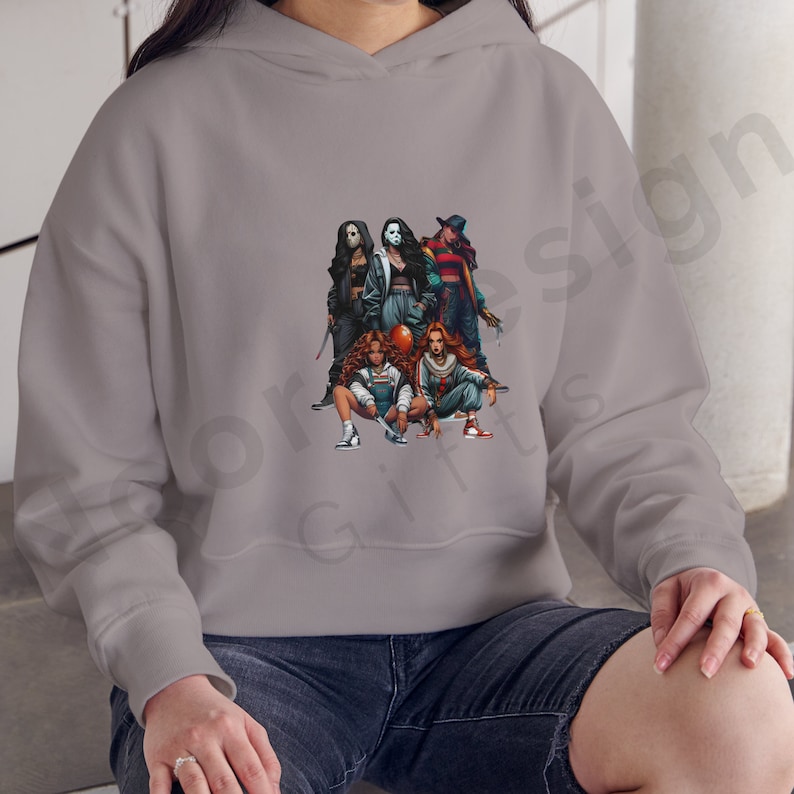 May include: A gray hoodie with a graphic print of five women dressed as horror movie characters. The women are holding weapons and wearing masks. The graphic is centered on the hoodie.