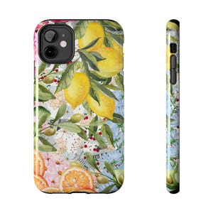 May include: A phone case featuring a floral and lemon design. The case has a white background with watercolour illustrations of lemons, flowers, and leaves. The case is designed for an iPhone.