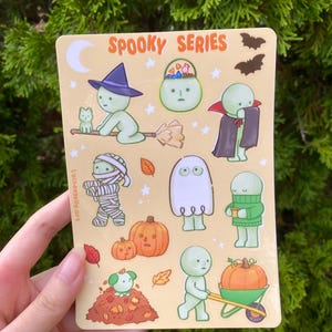 May include: A white ceramic mug with a black handle and the text "But First, Coffee" in a black, handwritten-style font. The mug is on a white surface.