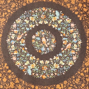 Orange/Brown floral wreath with bird quilting fabric. The Lovely Bunch collection.