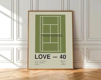 May include: A framed print featuring a tennis court illustration in shades of green and beige. The text "LOVE - 40" is displayed prominently, with additional text below. The artwork is in a wooden frame, leaning against a white wall.