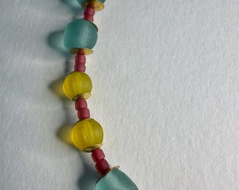 Necklace with recycled glass beads and small brass charms