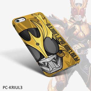 May include: A yellow and black phone case featuring a stylized illustration of a character's face. The design includes a gold helmet with flame-like accents, gray facial features, and the text "RISING ULTIMATE". The case is labeled "PC-KRIUL3".