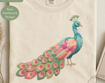May include: A cream-colored t-shirt featuring a graphic of a peacock with a faux patchwork design in shades of blue, pink, green, and orange. The text "PAUSE...never mind." is printed in black below the peacock illustration on the front of the shirt.