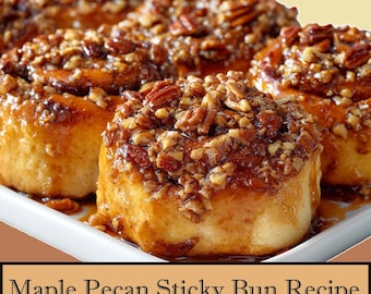 May include: A close-up of several maple pecan sticky buns on a white plate. The buns are golden brown, covered in a glossy glaze, and topped with chopped pecans. The text "Maple Pecan Sticky Bun Recipe" is at the bottom.