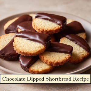 May include: A plate of chocolate-dipped shortbread biscuits. The biscuits are round with a light brown, crumbly texture, and are partially coated in a glossy, dark chocolate. The text "Chocolate Dipped Shortbread Recipe" is at the bottom.
