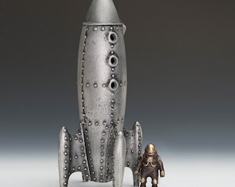 Moon Rocket Coin Bank with One Spaceman - Item #924, Cast Aluminum and Bronze