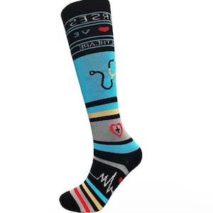 May include: Blue and black knee-high socks with a white and yellow stripe. The socks feature a red heart with a white cross, a stethoscope, and the text "NURSES ARE THE HEART OF HEALTHCARE".