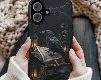 May include: Black phone case featuring a detailed illustration of a raven perched on an open book. The design includes gothic elements like lanterns and a dark forest background, creating a mysterious and artistic aesthetic.