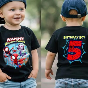 May include: Black t-shirt featuring Spider-Man and other characters with the text "Nanny Amazing Friends" on the front. The back of the shirt has "Birthday Boy" and a large number 5 with a spider web design.
