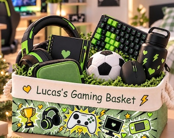May include: A rectangular fabric storage basket with rope handles, labelled Lucas's Gaming Basket, featuring green comic-style graphics of a trophy, headphones, controller, monitor, and handheld console, filled with gaming accessories.