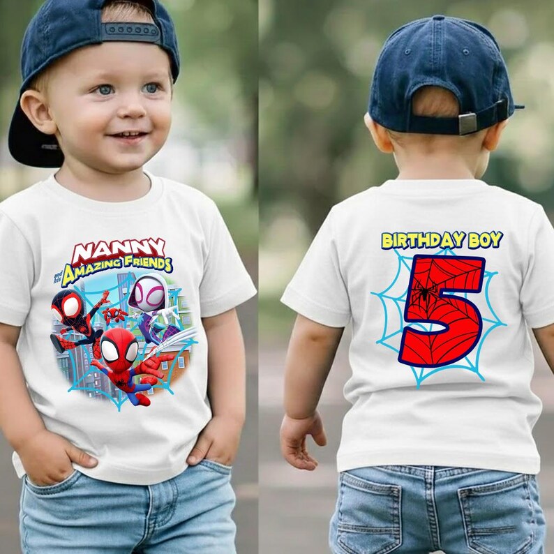 May include: White t-shirt featuring Spider-Man and other characters with the text "Nanny Amazing Friends" on the front. The back of the shirt has the text "Birthday Boy" and a large red number 5 with a spiderweb design.