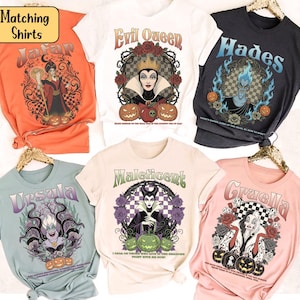 May include: A selection of six graphic t-shirts featuring Disney villains. Designs include Jafar, Evil Queen, Hades, Ursula, Maleficent, and Cruella. Each shirt has a unique illustration with text, and the shirts are in various colours.