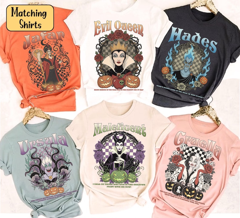 May include: A selection of six graphic t-shirts featuring Disney villains. Designs include Jafar, Evil Queen, Hades, Ursula, Maleficent, and Cruella. Each shirt has a unique illustration with text, and the shirts are in various colours.