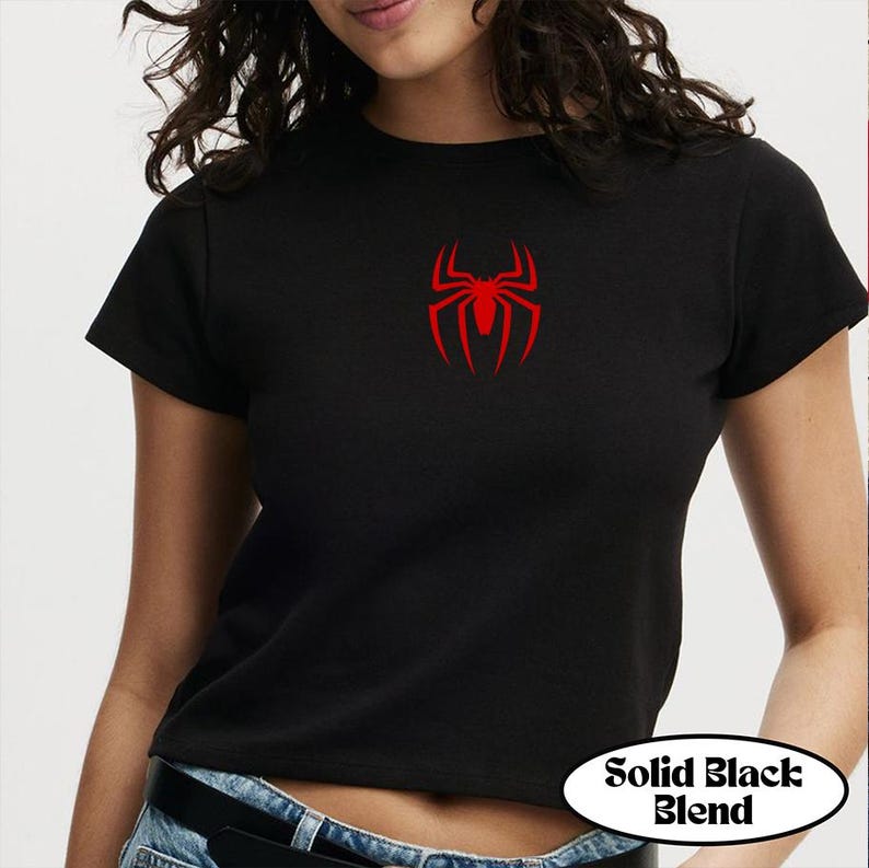 May include: Black crop top with a red spider emblem on the chest. The shirt has short sleeves and a crew neck. The text "Solid Black Blend" is in a white oval at the bottom.
