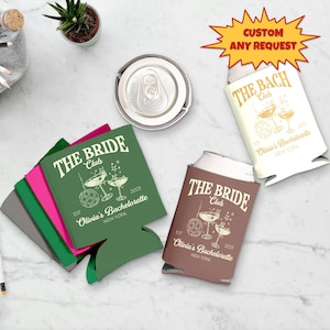 May include: Various can coolers in green, brown, and cream, printed with "THE BRIDE Club" or "THE BACH Club" text, cocktail and disco ball graphics, and "Olivia's Bachelorette NEW YORK". A can and a plant are also visible.