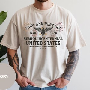 This USA 1776–2026 anniversary shirt is printed on authentic Comfort Colors® apparel for premium quality. The eagle and fireworks composition honors 250 years of freedom. With its vintage pigment dye and relaxed fit, this Comfort Colors® t-shirt is perfect for patriotic festivals and everyday Americana style.
