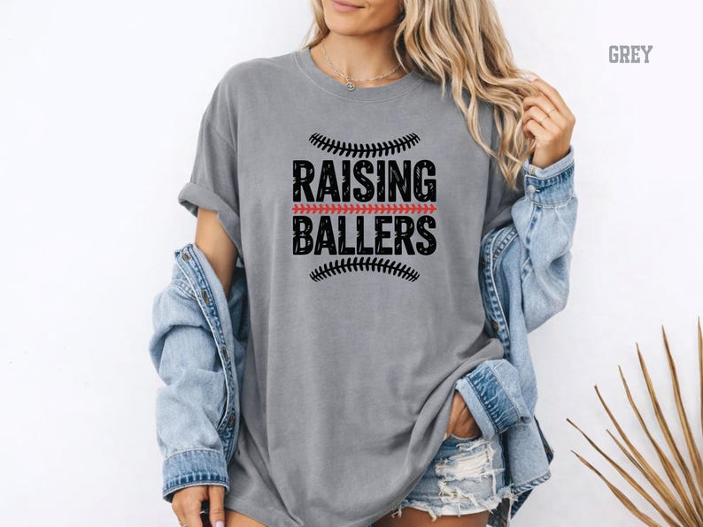 For moms who live at the ballpark, this Raising Ballers Comfort Colors® shirt is the perfect match. The relaxed fit and soft garment dyed fabric provide all day comfort while the sporty design celebrates the pride of raising young athletes. Perfect for baseball games, softball events, and casual outfits.