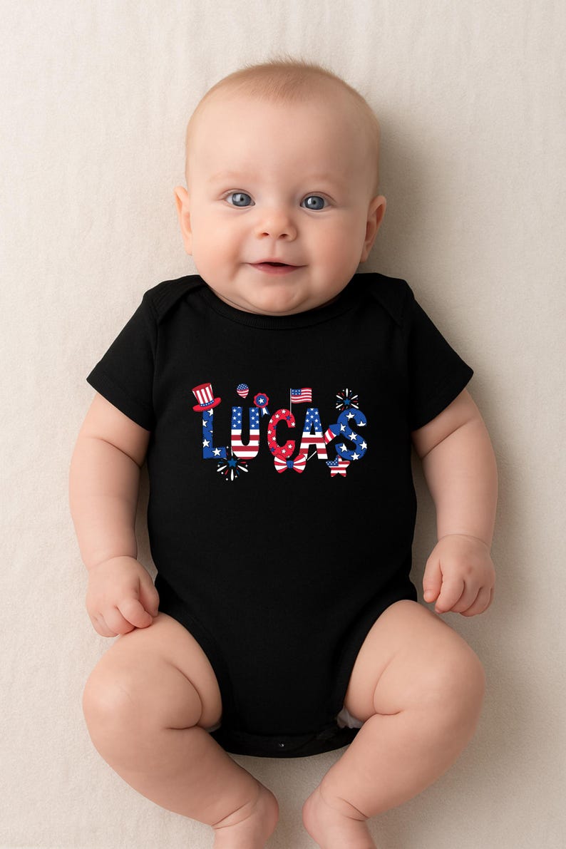 A smiling baby lies on a soft light background wearing a black personalized patriotic baby bodysuit with the custom name Lucas across the front. The name is styled in red, white, and blue with stars, stripes, fireworks, and festive patriotic accents for a bold Fourth of July look. This mockup showcases a custom baby outfit ideal for Independence Day, family holiday photos, matching sibling sets, and America’s 250th birthday celebration in 2026.
