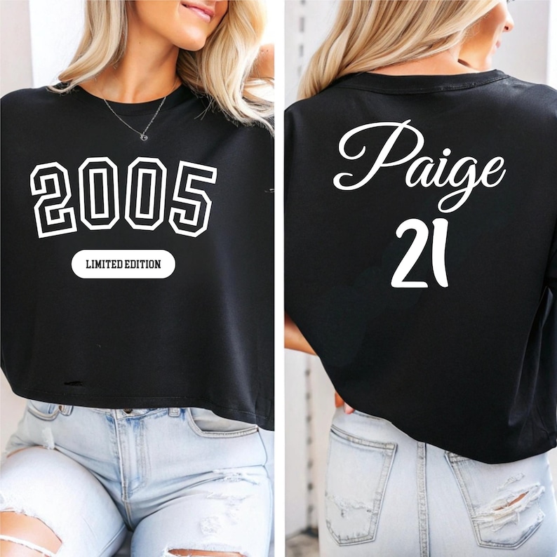 A woman wearing a black crop top with the number "2005" printed on it, and the name " Paige" printed below it.