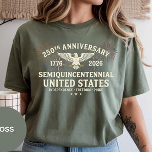 Commemorate America’s 250th Anniversary with this premium Comfort Colors® graphic tee. Fireworks accents and vintage eagle artwork create a timeless patriotic look. Soft-washed and garment-dyed, this Comfort Colors® shirt delivers a relaxed fit and lived-in comfort, making it perfect for Independence Day outfits or patriotic gifting.
