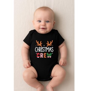 cute christmas crew sweatshirt with reindeer antlers and personalized sleeve name option, matching holiday family sweater for kids and adults, custom christmas shirt for winter celebrations, cozy xmas crew top with festive lettering, personalized holiday gift sweatshirt, christmas pajamas top for family photos, fun reindeer themed christmas sweater, holiday party outfit idea, custom name christmas crew shirt, adorable winter sweatshirt for holiday season