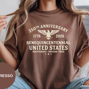 Show your American pride with this Semi-Quincentennial Comfort Colors® t-shirt. The classic collegiate lettering, heritage dates, and celebratory fireworks make it a standout design for 4th of July events. Crafted from soft ring-spun cotton, this Comfort Colors® tee offers breathable comfort with a retro aesthetic.