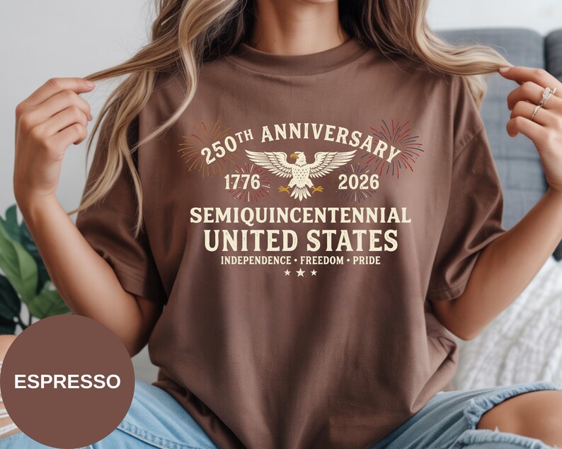 Show your American pride with this Semi-Quincentennial Comfort Colors® t-shirt. The classic collegiate lettering, heritage dates, and celebratory fireworks make it a standout design for 4th of July events. Crafted from soft ring-spun cotton, this Comfort Colors® tee offers breathable comfort with a retro aesthetic.