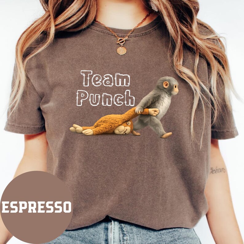 A woman wearing a brown t-shirt with a graphic of a monkey and the text "Team Punch" printed on it.