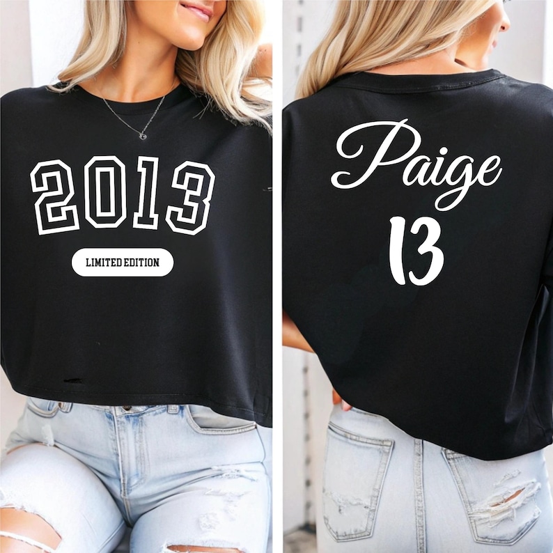 A woman wearing a black cropped t-shirt with the text "2013" and " Paige 13" printed on it.