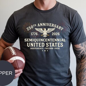 Mark the historic Semi-Quincentennial milestone with this patriotic Comfort Colors® t-shirt. Designed with classic USA typography, fireworks bursts, and a proud eagle centerpiece, it’s ideal for July 4th celebrations and national events. Made from high-quality ring-spun cotton, this Comfort Colors® tee offers superior softness, relaxed fit, and long-lasting print quality for true American spirit lovers.