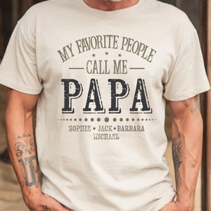 a man wearing a white t - shirt that says my favorite people call me papa