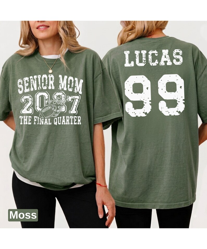 A woman wearing a green t-shirt with text and numbers printed on it.