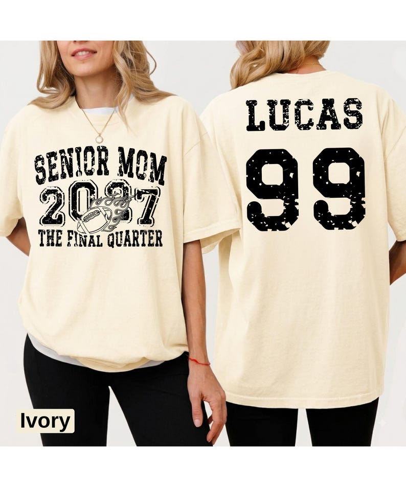 A woman wearing a white t-shirt with text and numbers printed on it.