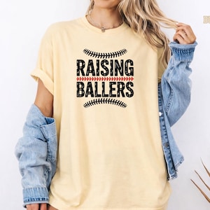 Raising Ballers perfectly describes the life of a dedicated sports mom. This Comfort Colors® baseball mom shirt features a classic sporty design that looks great at the ballpark or anywhere. The soft garment dyed cotton gives a relaxed vintage feel that makes it a favorite for game days and everyday wear.