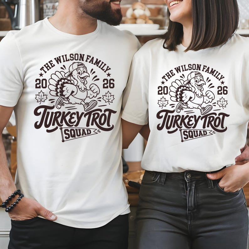 Two people wearing white t-shirts with a turkey trot squad design.