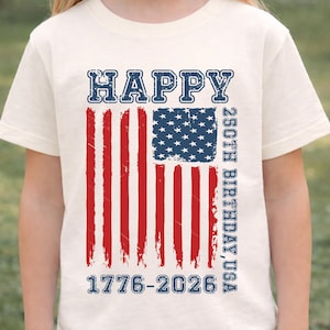Looking for a unique patriotic shirt for 2026? This kids USA birthday shirt celebrates 250 years of American history with a bold distressed flag and classic red, white, and blue theme. It is a fun and meaningful choice for children to wear during Fourth of July festivities, patriotic school programs, Memorial Day weekend, Veterans Day events, or family holiday gatherings. A memorable commemorative design for America’s quarter millennium celebration.