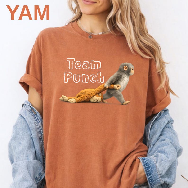 A woman wearing a red t-shirt with a graphic of a monkey and the text "Team Punch" printed on it.