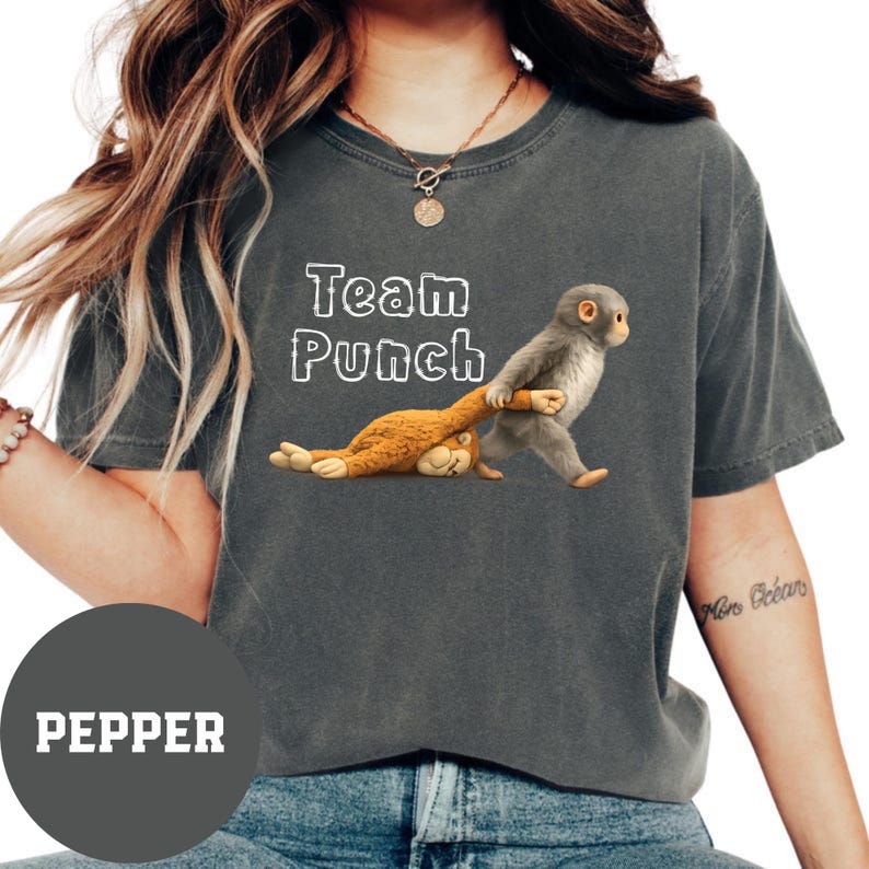 A person wearing a gray t-shirt with a graphic of a monkey and the text "Team Punch" printed on it.
