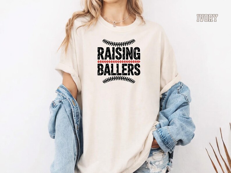 Celebrate baseball season in style with this Raising Ballers Comfort Colors® shirt. Designed for baseball moms and softball moms, this comfortable vintage tee is ideal for cheering from the stands, attending tournaments, and supporting your young athletes. A thoughtful gift for proud sports moms.