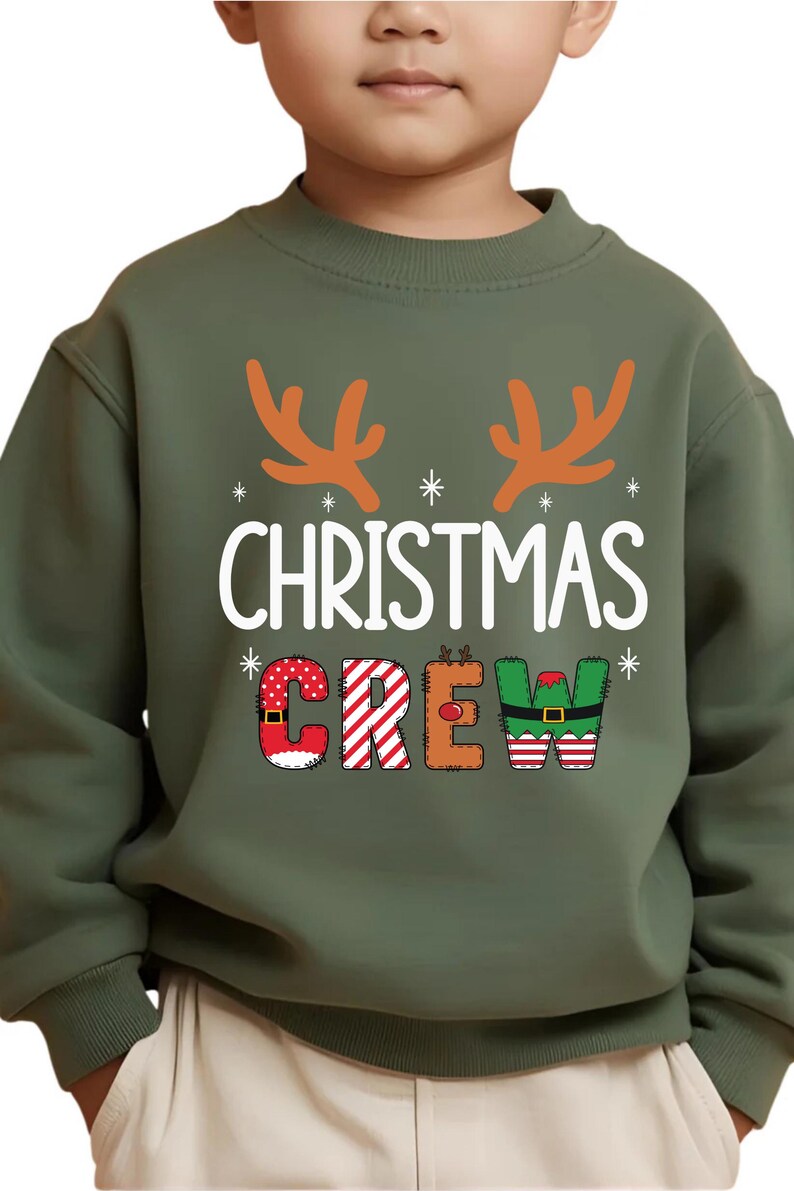 cute christmas crew sweatshirt with reindeer antlers and personalized sleeve name option, matching holiday family sweater for kids and adults, custom christmas shirt for winter celebrations, cozy xmas crew top with festive lettering, personalized holiday gift sweatshirt, christmas pajamas top for family photos, fun reindeer themed christmas sweater, holiday party outfit idea, custom name christmas crew shirt, adorable winter sweatshirt for holiday season