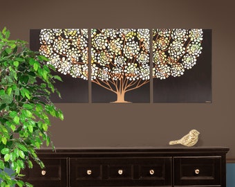May include: A three-panel wall art set featuring a stylized tree with a dark brown background and a canopy of white, cream, and light orange circular floral patterns. The tree trunk and branches are a solid light brown color against the dark backdrop.